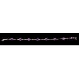 An amethyst bracelet, set with oval cut amethysts in twisting settings, 18.5cm long, together with