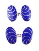 A pair of silver and enamel double sided cufflinks, the oval panels with swirled enamel detail,