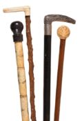 Ω Four various walking sticks, the first Chinese sectional bone, early 20th century, with a