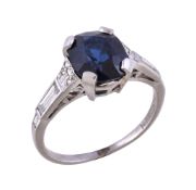 A 1920s sapphire and diamond ring, the oval cut sapphire in a four claw setting, between rose cut