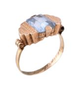 A 1940s aquamarine ring, the rectangular cut aquamarine between geometric shoulders, the inner