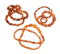 An amber bead necklace , the graduated oval beads, to a amber coloured clasp; together with a