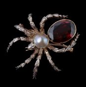 A garnet and diamond spider brooch, the body set with an oval cut garnet and a mabe pearl, the head