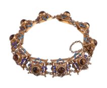 A silver gilt and tiger's eye quartz bracelet, the square domed panels with blue enamel detail,