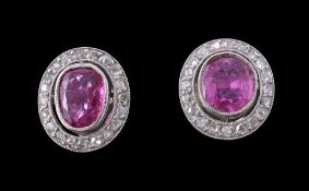 A pair of ruby, pink sapphire and diamond cluster ear studs, the oval cut ruby and pink sapphire