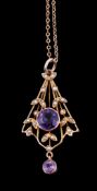 An early 20th century amethyst and seed pearl pendant, the circular cut amethyst collet set within