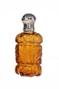 A Victorian silver mounted amber cut glass scent bottle, unmarked, mid 19th century, with a lobed