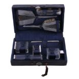 Ω A cased silver mounted eight piece travelling dressing table set by Collett & Anderson, London