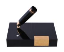 Montblanc, Meisterstuck, a black desk stand with pen holder, the rectangular base with a swivel pen