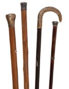 Four silver coloured mounted walking sticks, mainly early 20th century, the silver gilt example