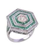 An emerald and diamond cluster ring, the central brilliant cut diamond, estimated to weigh 1.00