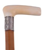 Ω A Continental ivory mounted gadget walking stick, circa 1900, the ivory handle with a white alloy