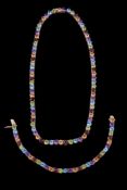 A multi gem set necklace, set with alternating citrines, amethysts, blue topaz, peridot and garnet,