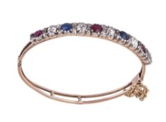 A Victorian and later diamond, ruby and sapphire bracelet, set with alternating oval cut rubies,