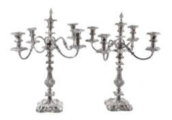 A pair of old Sheffield plate five light four branch candelabra, unmarked, circa 1820, with a