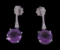 A pair of amethyst and diamond earrings, the circular cut amethyst in a four claw setting suspended
