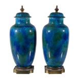 Paul Milet (1870-1950), a pair of earthenware jars and covers, with gilt metal finials and bases,