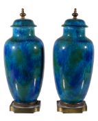 Paul Milet (1870-1950), a pair of earthenware jars and covers, with gilt metal finials and bases,