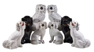 Four various Staffordshire models of spaniels , late 19th century and later, 34cm high and smaller