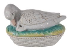 A Staffordshire duck tureen cover and ozier-moulded base, circa 1900, sparsely coloured and gilt,