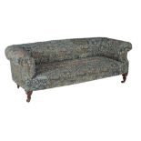 A mahogany and upholstered sofa, covered with original Morris & Co. woven fabric, circa 1920, the