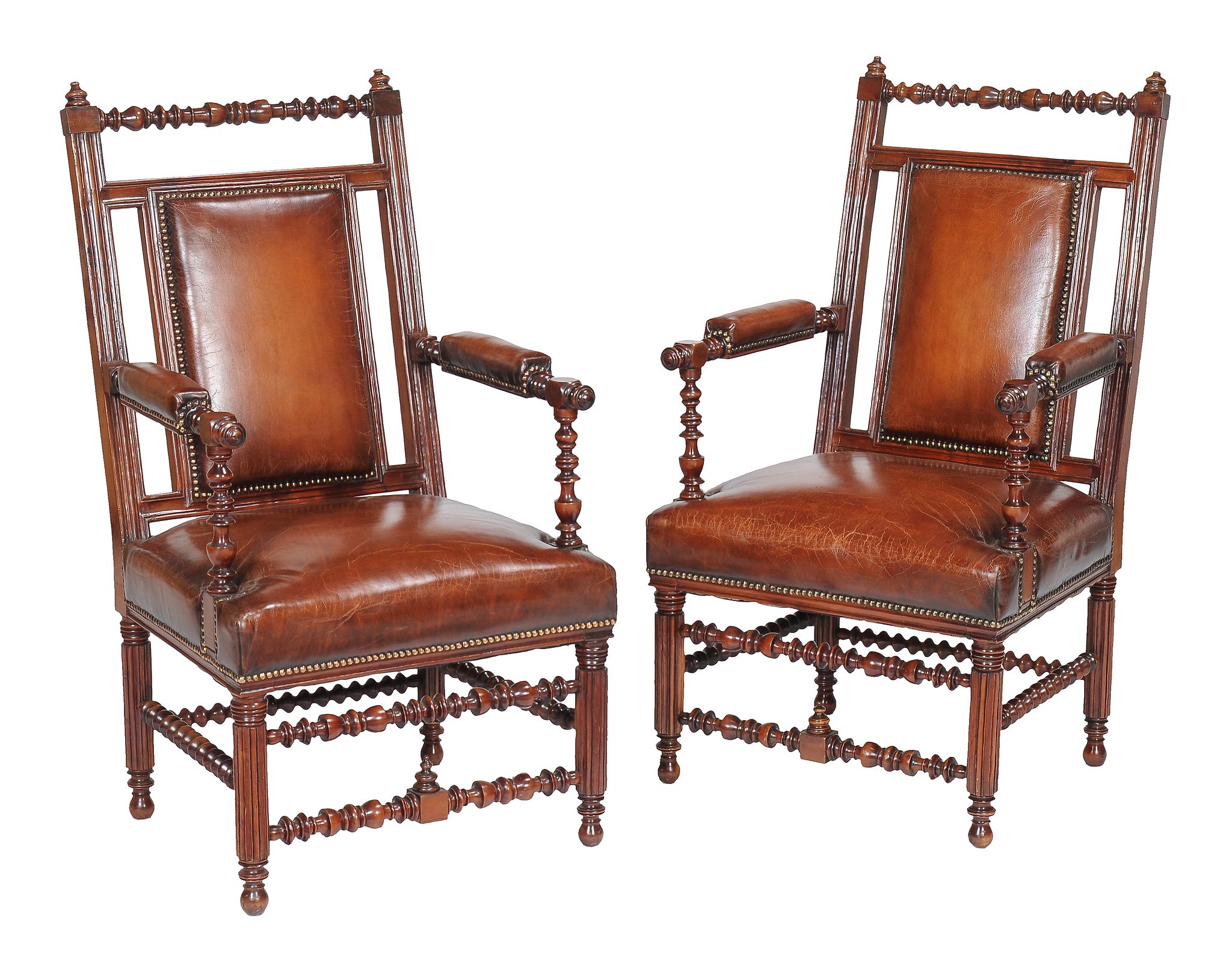 A pair of Reformed Gothic walnut and leather upholstered armchairs , 1870s, in the manner of Bruce