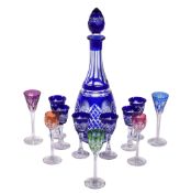 A Czechoslovakian clear cut glass and blue flashed spirit set , comprising a slender decanter and