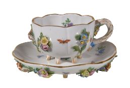 A Meissen flower-encrusted cabinet cup and saucer, late 19th century, typically painted with