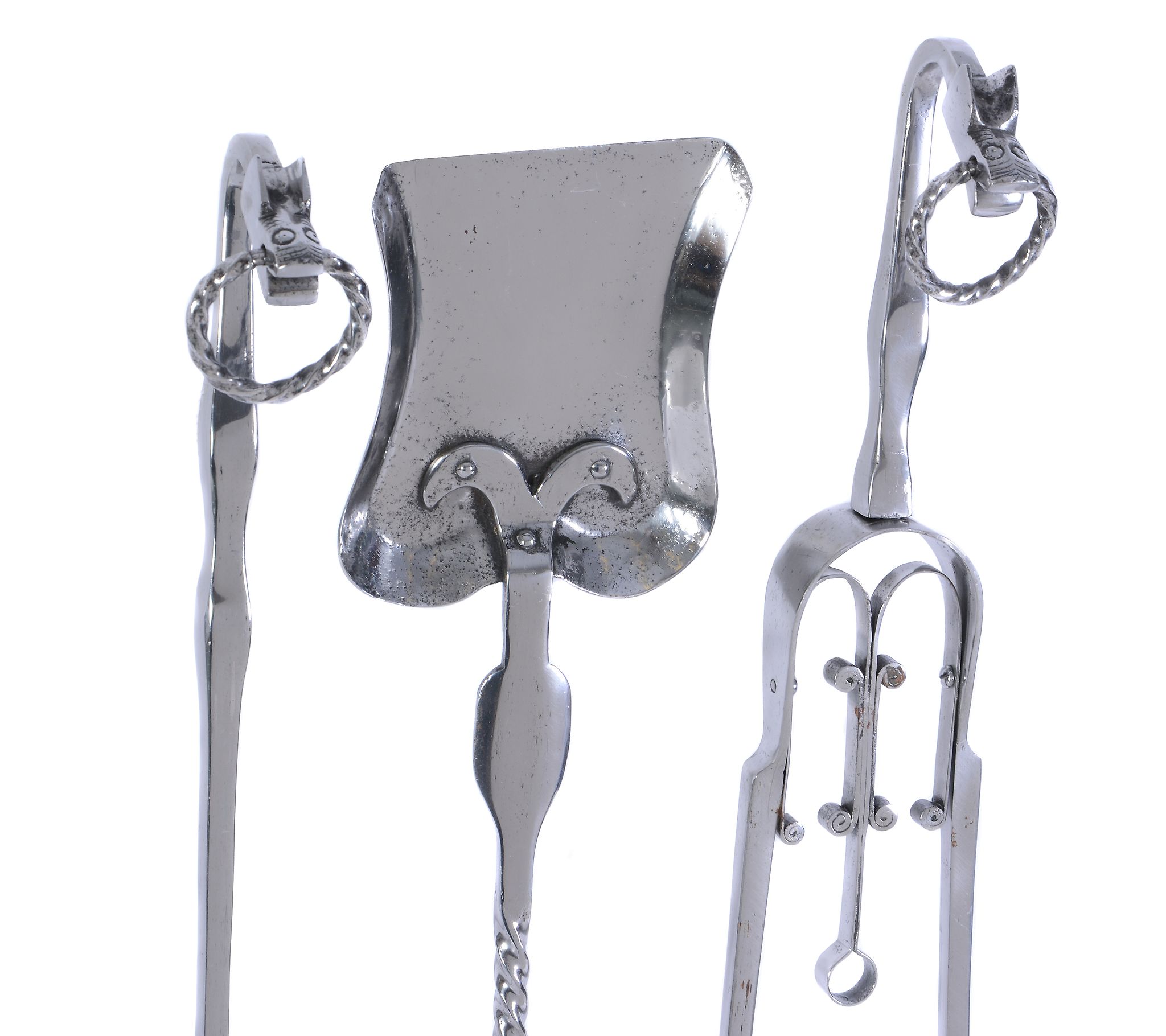 An Arts and Crafts set of three polished steel fire tools, with twist rings to the terminals and