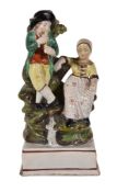 A pearlware group of a flautist and companion, first quarter 19th century, 18cm high