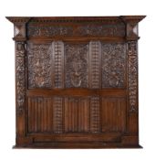 A carved and stained oak panel in 17th century style , early 20th century, with heraldic motifs
