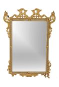 A giltwood wall mirror , circa 1900 and with later plates, 122cm high, 90cm wide Provenance: From