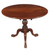 A George III mahogany tripod table , circa 1780, the single plank top above a turned column and