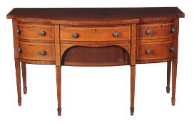 A George III mahogany sideboard , circa 1790, of break-bowfront outline, with arrangement of