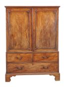 A George III mahogany clothes press, circa 1780, the pair of panelled doors opening to five sliding