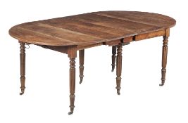 A Regency mahogany extending dining table, circa 1815, the oval shaped top incorporating a hinged