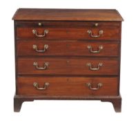 A George III mahogany chest of drawers, circa 1770, with baize lined slide above four long drawers,