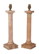 A pair of polished stone columnar table lamps, last quarter 20th century, the electrical fitments