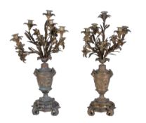A pair of French parcel gilt and patinated bronze five light candelabra, last quarter 19th century,