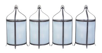 A set of four patinated metal and opaque glass wall lanterns, second half 20th century, each of