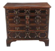 A Charles II oak chest of drawers, circa 1680, with four long graduated drawers each with a