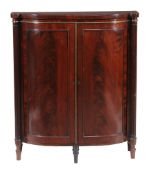 A Regency mahogany side cabinet , circa 1815, the panel doors enclosing two fixed shelves, 92cm