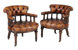 A pair of Victorian mahogany and brown leather upholstered tub armchairs , circa 1870, with fluted