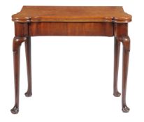 A George II mahogany card table , circa 1740, with rounded castellated corners, the top opening to