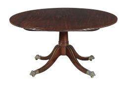 A George IV mahogany and brass strung breakfast table , circa 1825, the circular tilt top above