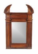 An Italian walnut wall mirror, first half 18th century, of architectural design, the rectangular