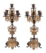 A pair of French gilt and patinated metal five light candelabra, late 19th century, each with a