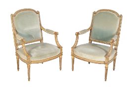 A pair of giltwood armchairs in Louis XVI style, late 19th century, each with green velvet