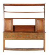 An ash and elm dresser , 19th century, the platerack with two cupboards above the base with three