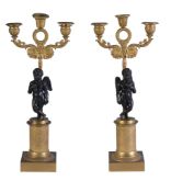 A pair of Empire gilt and patinated bronze three light figural candelabra, early 19th century, each